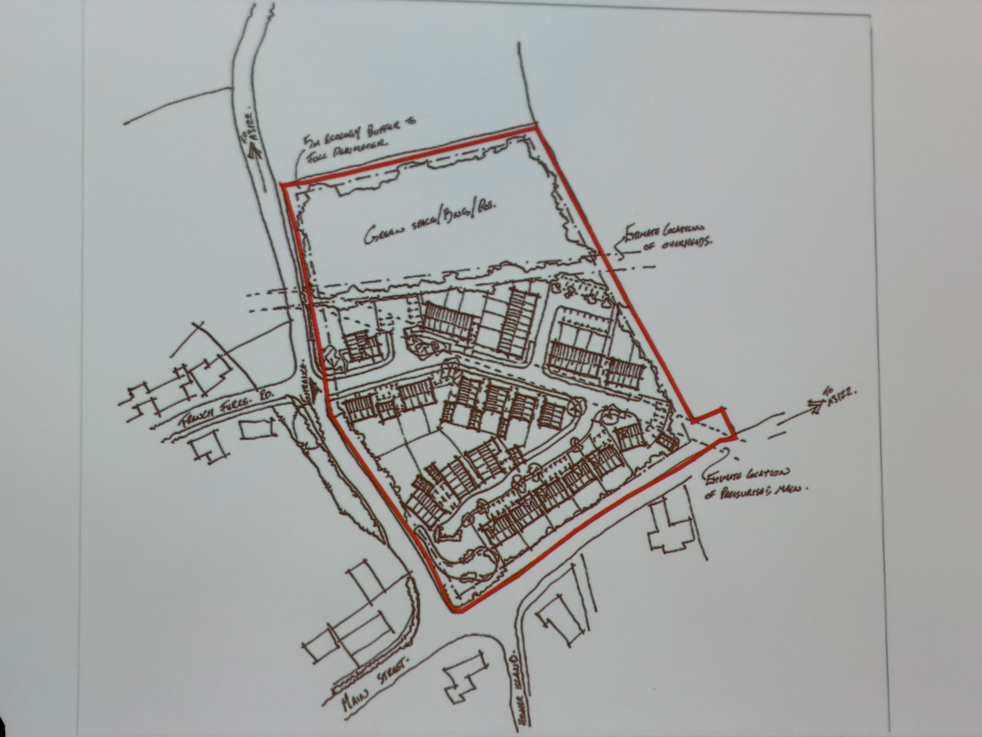 Photographed early layout sketch showing possible homes and an entrance opposite French Furze, with a large green area to the north and approximate infrastructure constraints.